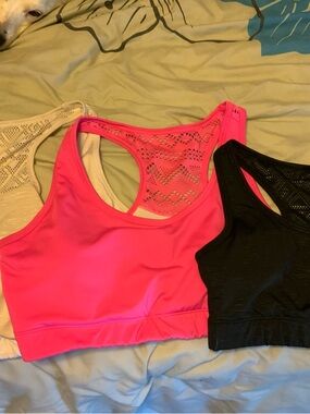 Three ZYIA Racerback Sports Bras with Lace Back. White, pink, and black.